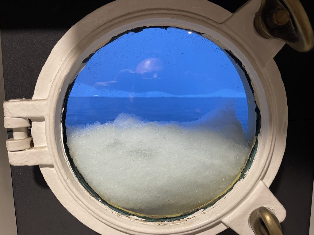 Ice visible through a porthole aboard M/S Tulu during winter operations in Greenland