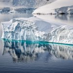 Large iceberg floating in calm Arctic waters along Greenland’s west coast