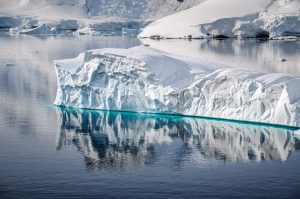 Large iceberg floating in calm Arctic waters along Greenland’s west coast
