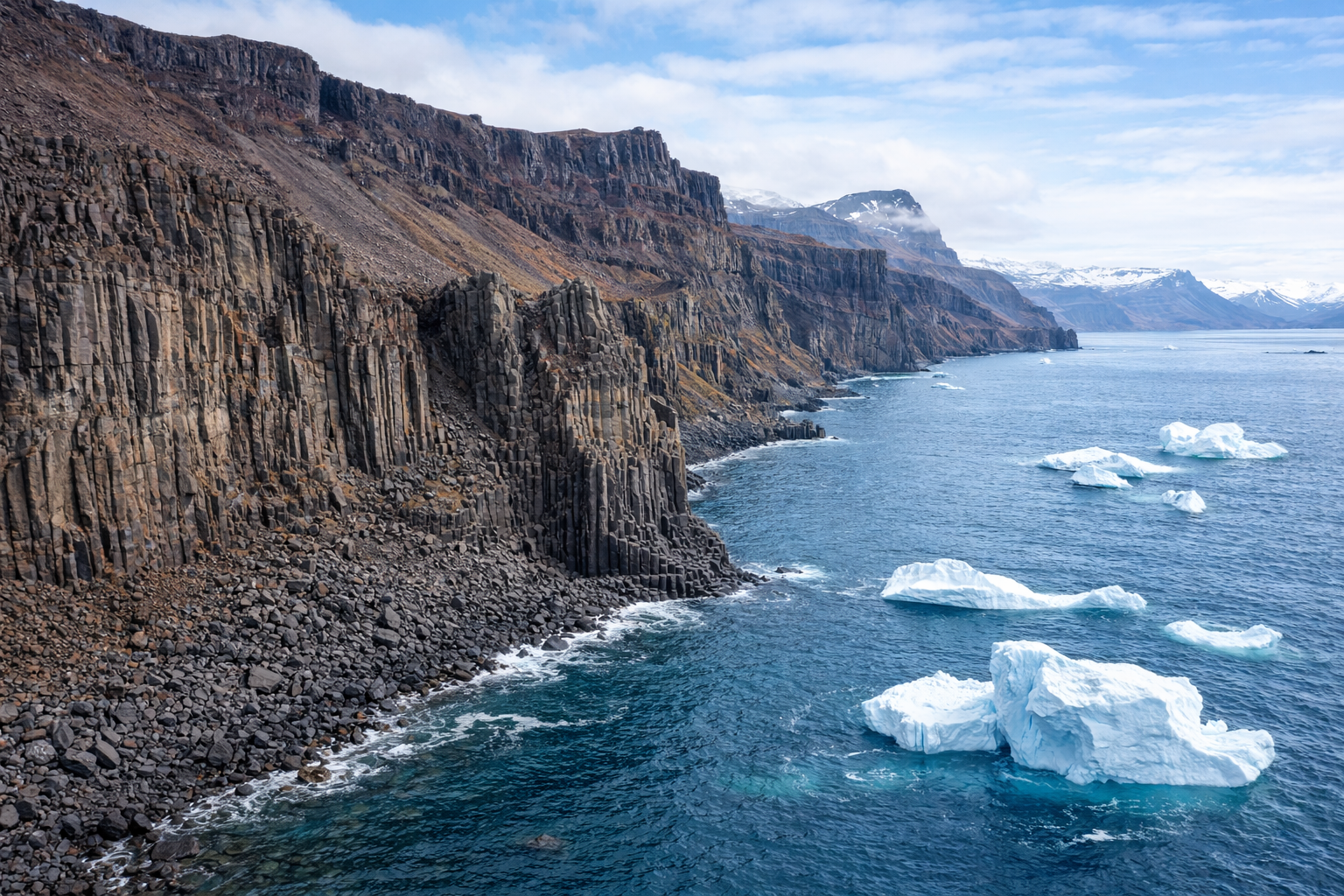 Basalt Cliff of Disko Island overshadowing icebergs