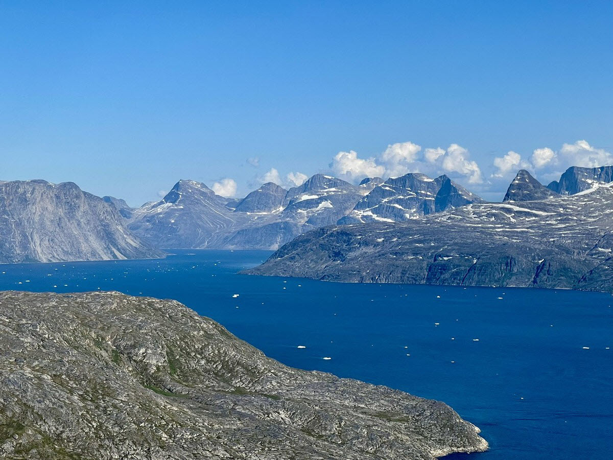 Mountainous fjord coastline with drifting ice in Greenland