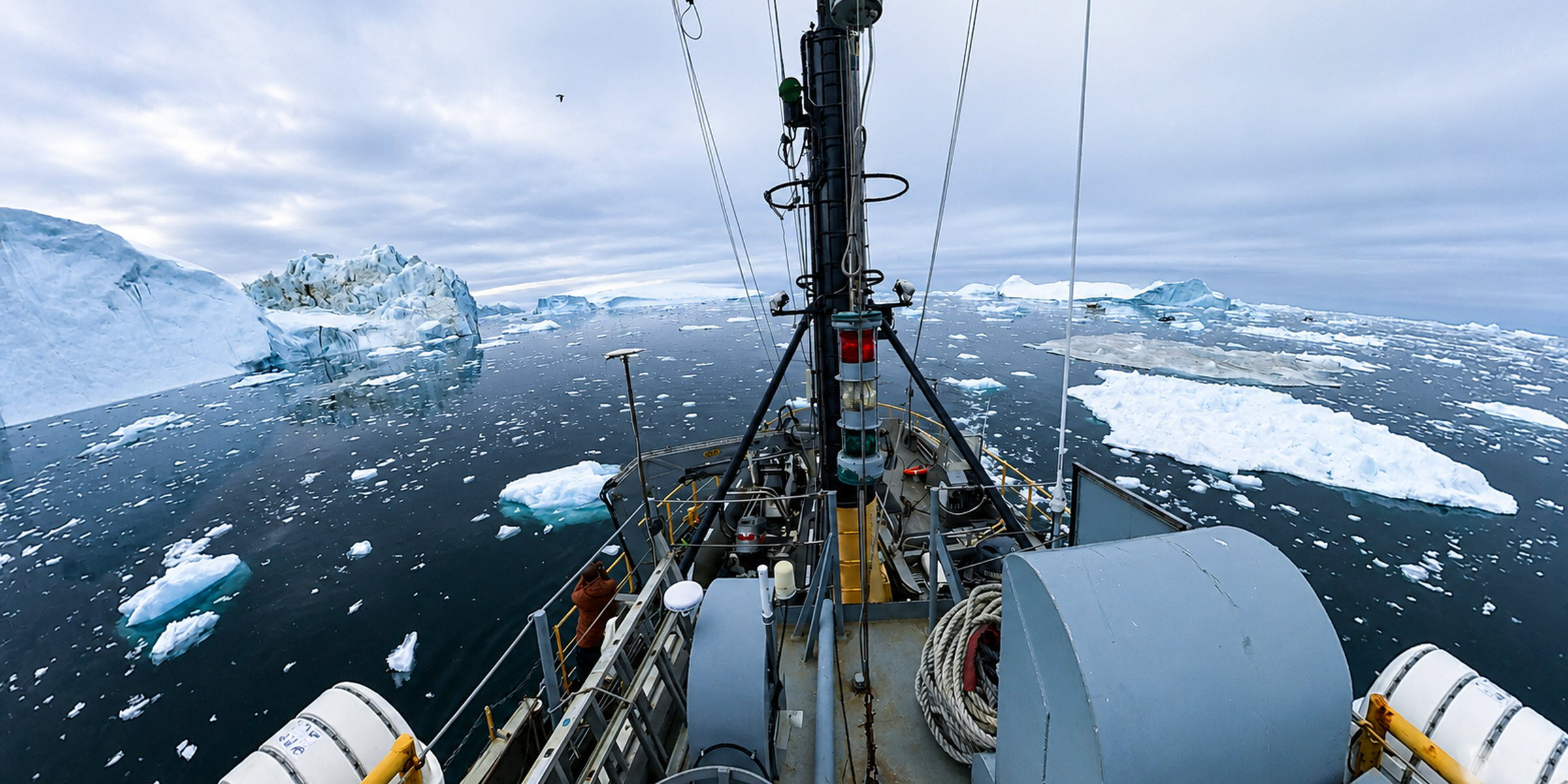View from the mast of M/S Tulu picking through icebergs and sea ice in Greenland