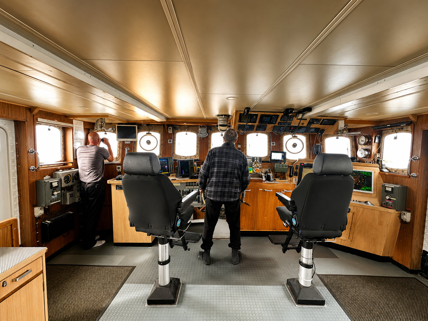 The wheelhouse aboard M/S Tulu, crew at the helm with navigation instruments
