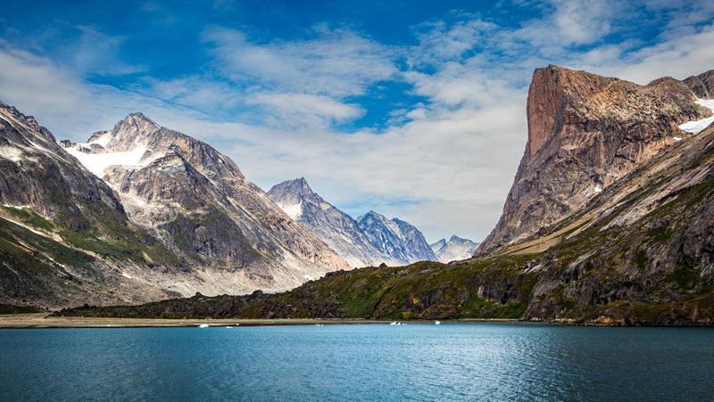 Mountains towering over a fjord in Greenland
