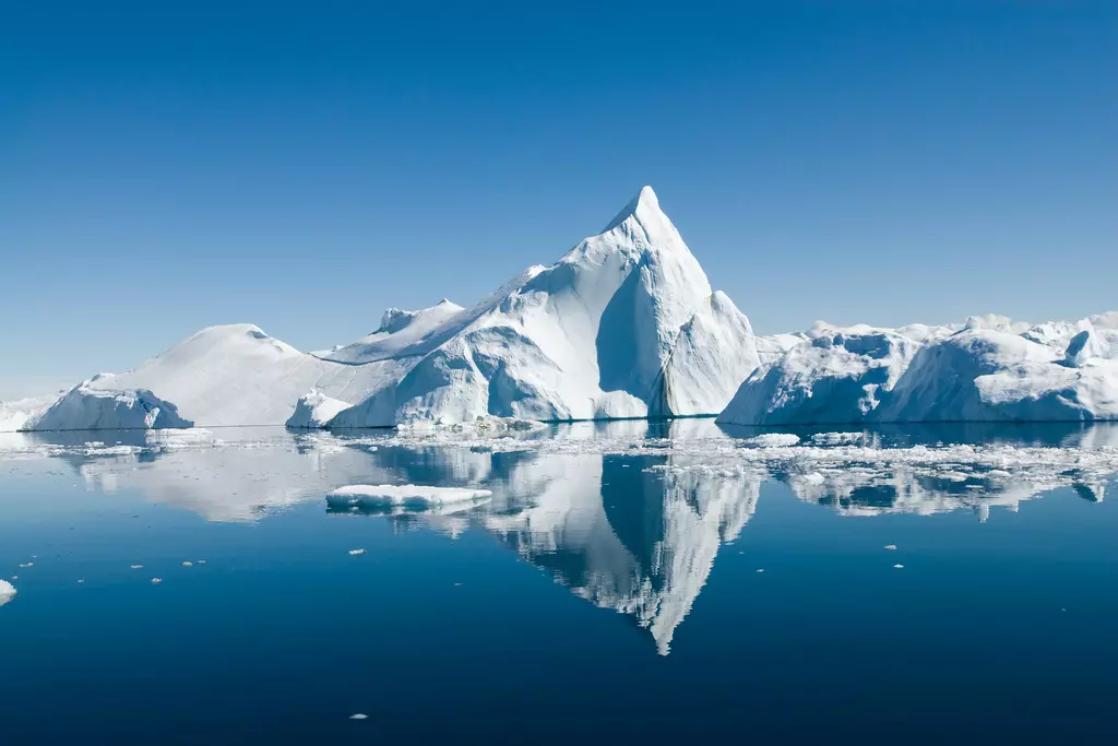 Icebergs reflected in still water at Disko Bay, Greenland